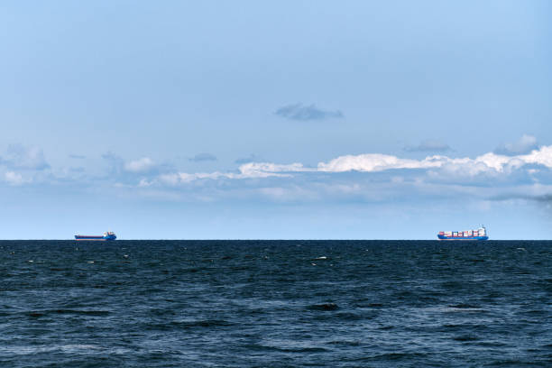 istock Container cargo ships freighters in distance, import export logistic, cargo ships in blue sea 1351129277