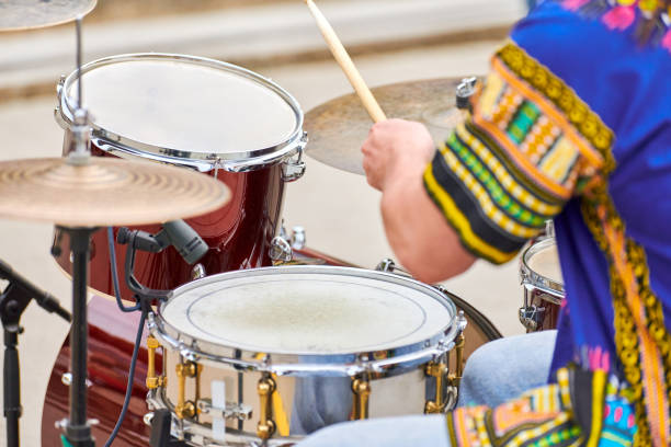istock Drummer man playing drums percussion with sticks, drum kit on concert stage, drumsticks and drums 1351129278