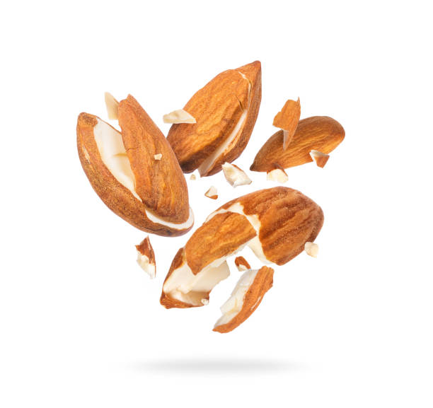 istock Dried almonds crushed in air into many pieces isolated on white background 1351132069