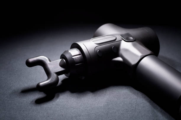 istock Massage gun. Handheld wireless professional therapeutic shock massage gun. 1351132103