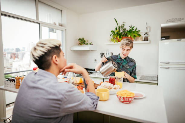 istock Lesbian couple at home, having healthy breakfast together 1351132348