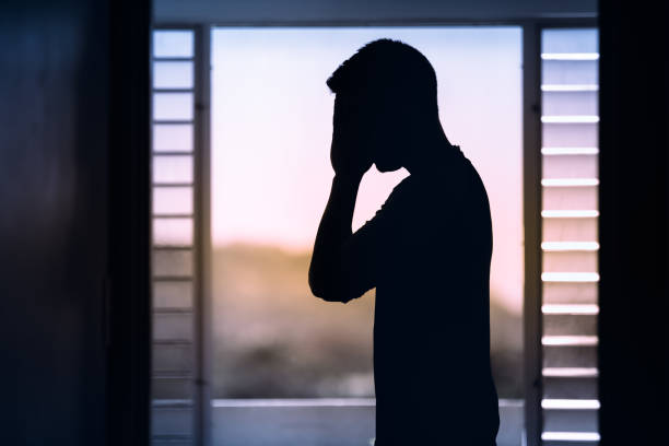 istock Stressed, depressed young man covering his face. 1351146231