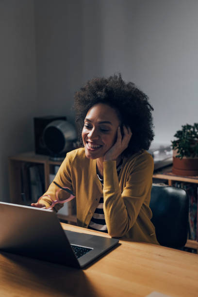 istock Smiling Business Woman Using Laptop Computer at Night 1351146379
