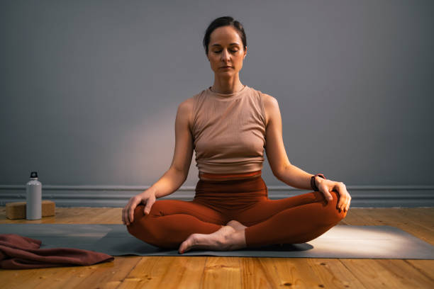 istock Young Woman Practicing Yoga Over a Gray Wall 1351147691