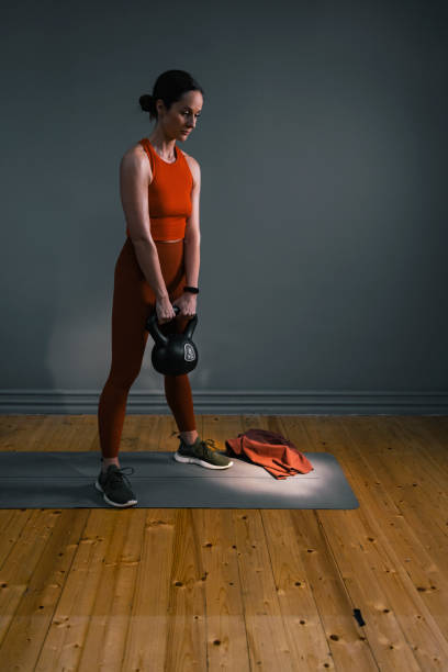 istock Serious Woman Exercising with Kettlebell Weights 1351147717