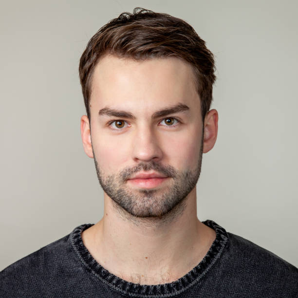 Studio portrait of attractive 20 year old bearded man
