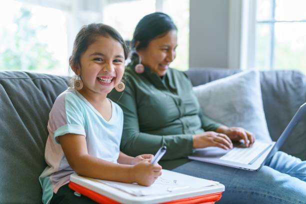 Happy Native American girl spending time with her mom stock photo