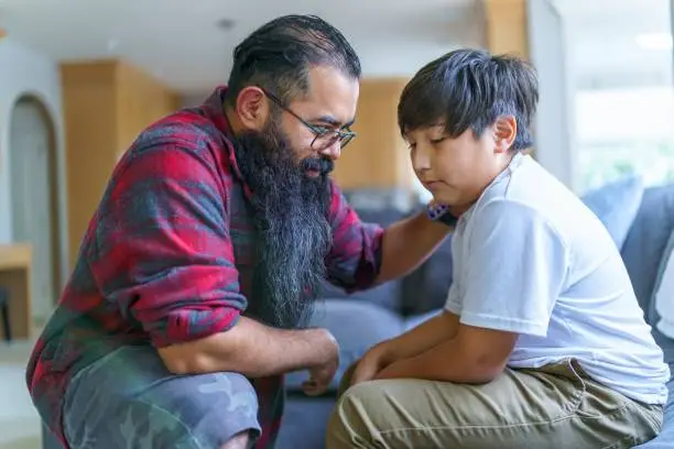 Photo of Dad having serious conversation with his son