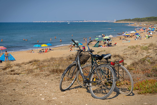 Torre Astura, Italy - September 12, 2021, Two bicycles parked near the beach in Torre Astura, Lazio, Italy