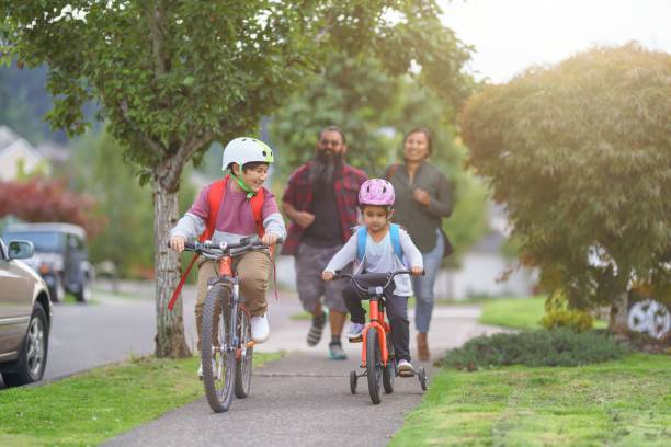 istock Happy Native American siblings riding their bikes to school 1351151063