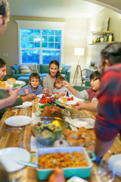 istock Family eating together at holiday table 1351151090