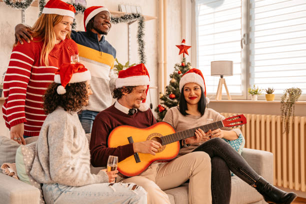 istock Friends celebrate Christmas playing guitar and singing 1351151507