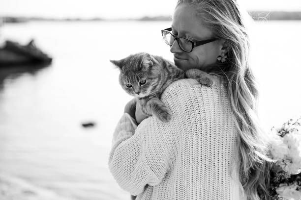 istock Woman Blonde hugging a scottish kitten on a walk 1351153082