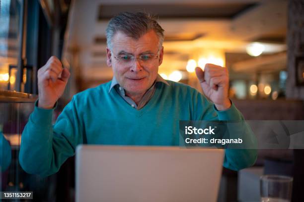Senior Man Watching A Sport Match Stock Photo - Download Image Now - Men, Excitement, Restaurant