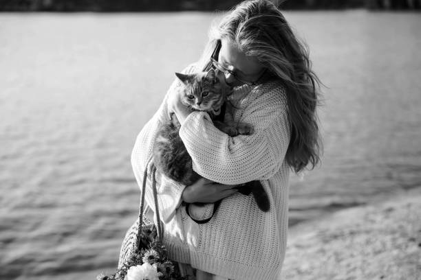 istock Woman blonde hugging a kitten on a walk 1351153288