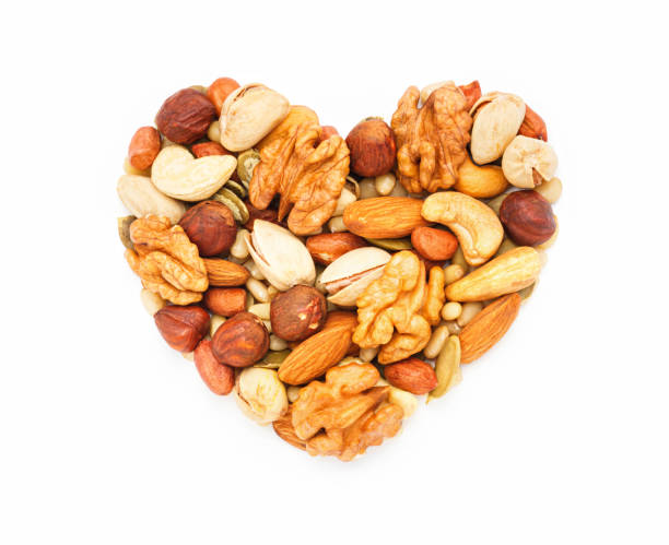 istock Heart shaped nuts and seeds isolated on white background close-up 1351153437