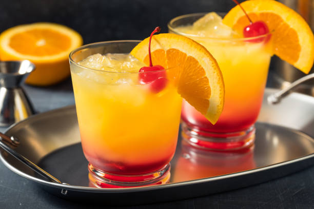 Boozy Cold Tequila Sunrise Cocktail Boozy Cold Tequila Sunrise Cocktail with Grenadine tequila sunrise stock pictures, royalty-free photos & images