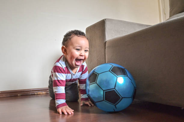 istock Cute baby playing with a ball 1351156400