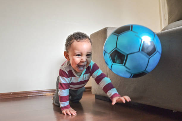 istock Cute baby playing with a ball 1351156404