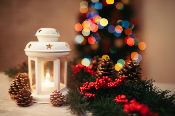 Christmas backgrounds: Christmas lantern on rustic wooden table with Christmas ornaments