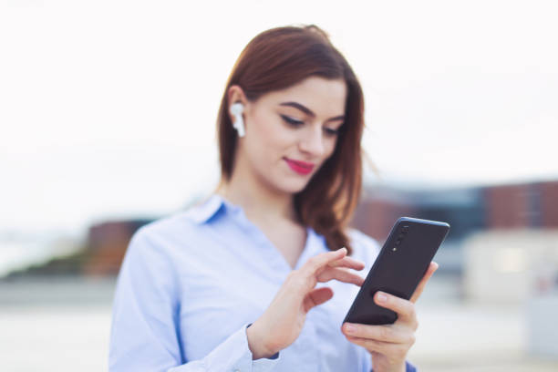 istock Young redhead manager using mobile phone outdoors 1351156802