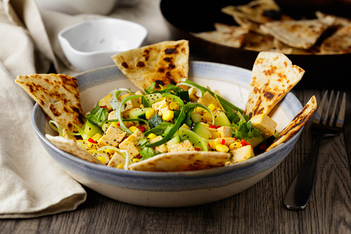 Homemade freshness fried tofu with sweet corn, spring onion, fine chopped red chilli pepper, cucumber, and grilled tortilla triangles and chia seeds. Serve with vinaigrette dressing