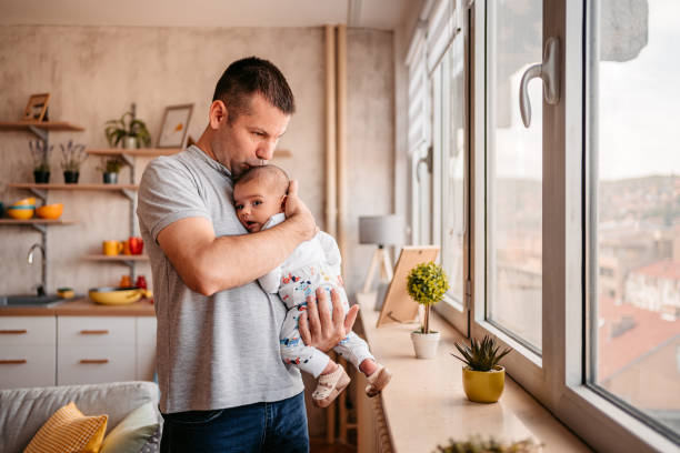 istock Proud father kissing newborn son 1351159845