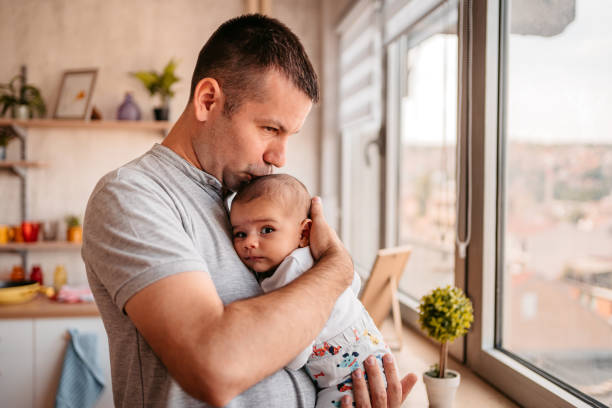 istock Proud father kissing newborn son 1351159870