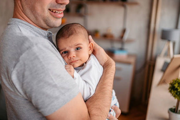 istock Proud father holding newborn son 1351159883