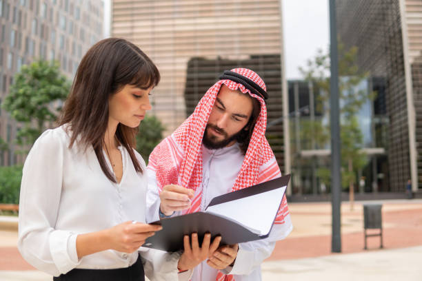 istock Serious Arab man signing contract on street 1351162175