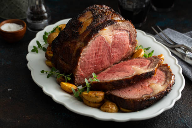 Boneless beef roast on a serving platter sliced stock photo