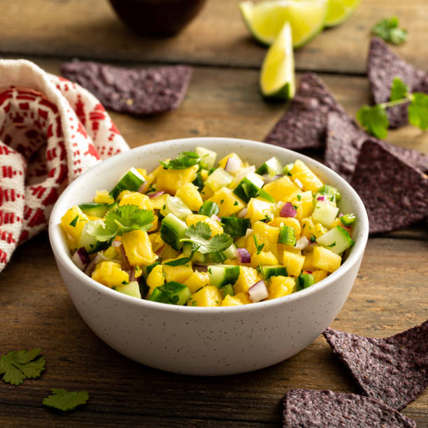 Pineapple and cucumber salsa with jalapeno and red onion stock photo