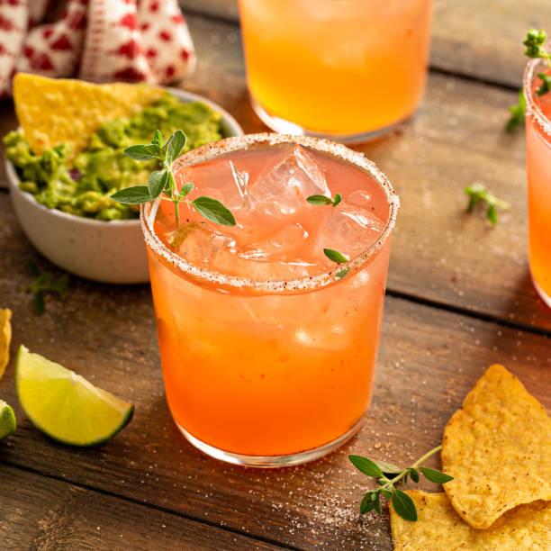 Spicy grapefruit margarita with chips and guacamole stock photo