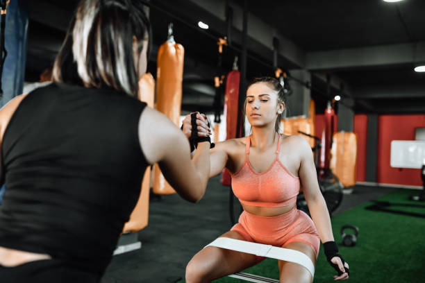 istock Motivation For Female Athletes Holding Hands During Gym Squats 1351168330