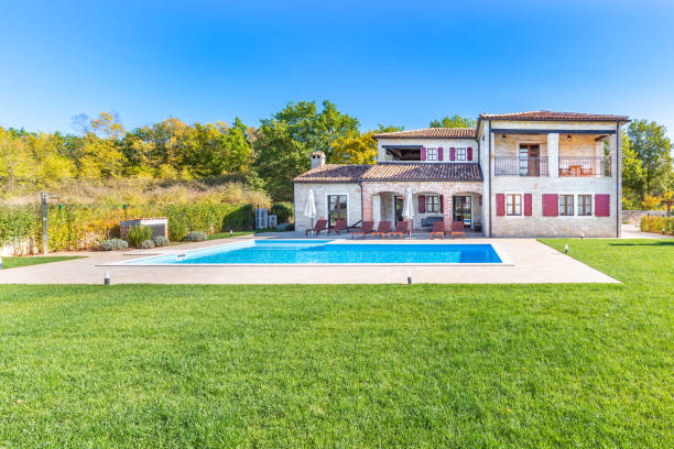 istock Luxurious beautiful modern villa with swimming pool and yard garden 1351168588