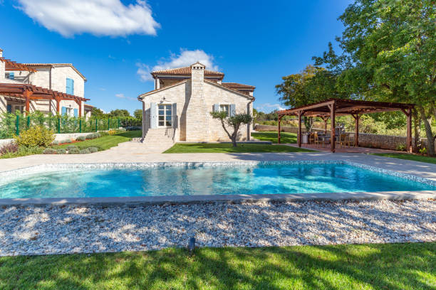 istock Luxurious beautiful modern villa with swimming pool and yard garden 1351168614