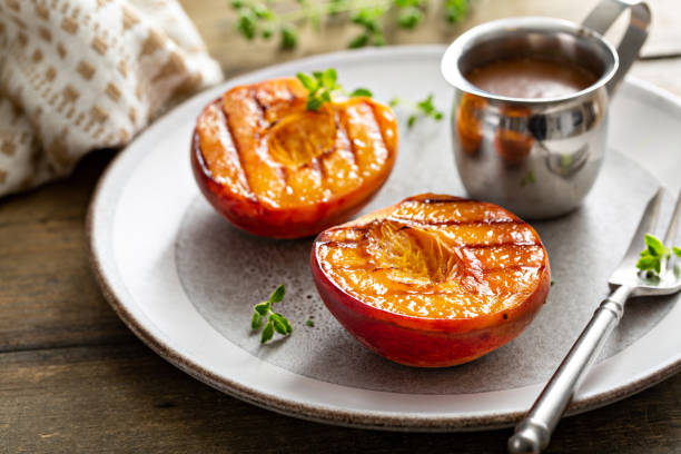 istock Grilled peaches with caramel sauce, summer dessert 1351168698