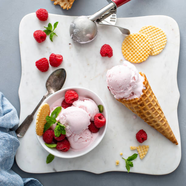 istock Raspberry ice cream in a bowl and conw with fresh berries 1351168704