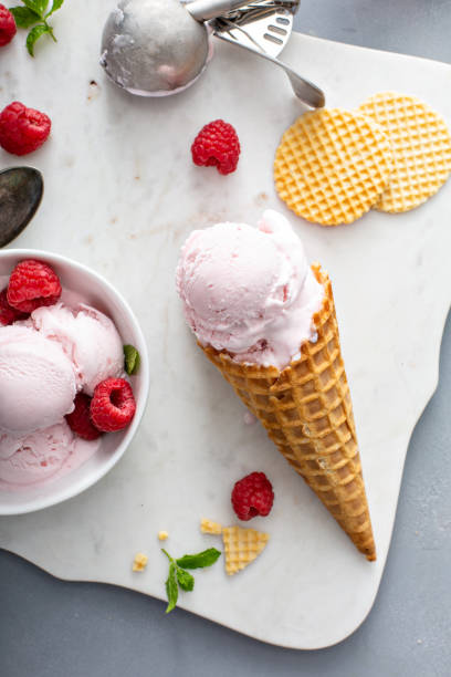 istock Raspberry ice cream in a bowl and conw with fresh berries 1351168713