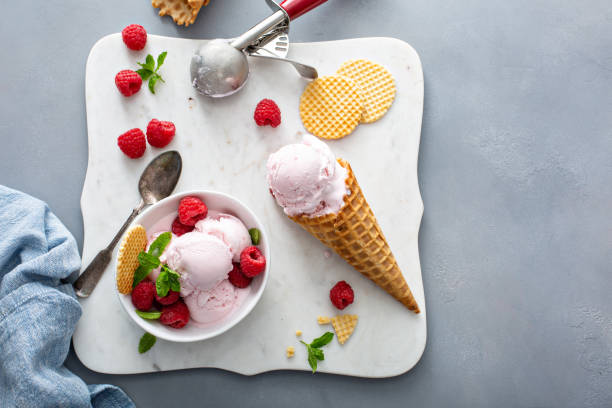 istock Raspberry ice cream in a bowl and conw with fresh berries 1351168717