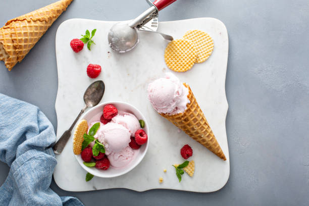 istock Raspberry ice cream in a bowl and conw with fresh berries 1351168720