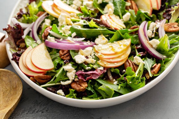 istock Winter salad with apple and pecans with vinaigrette dressing 1351168745