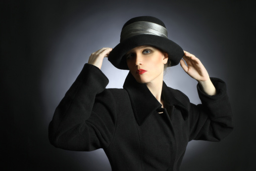 Elegant woman in black hat and coat. Portrait of pretty woman in autumn dress.