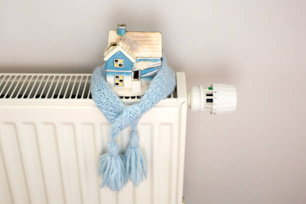 istock House model in a blue scarf on a radiator 1351172450