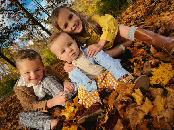 Fall Leaves Young siblings out enjoying a beautiful autumn afternoon! 6 9 months stock pictures, royalty-free photos & images