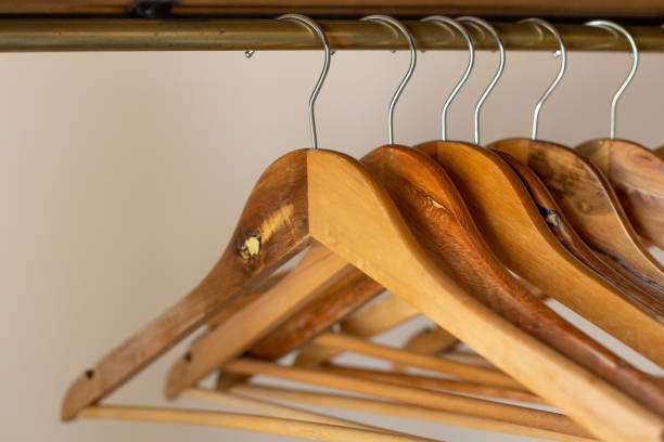 Rack with wooden clothes hangers on a white background. Retro style.