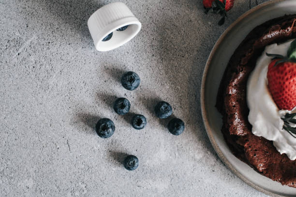 istock Fresh blueberries with flourless chocolate cake on rustic table. Blueberry antioxidant organic superfood. Concept for healthy eating and nutrition 1351173936
