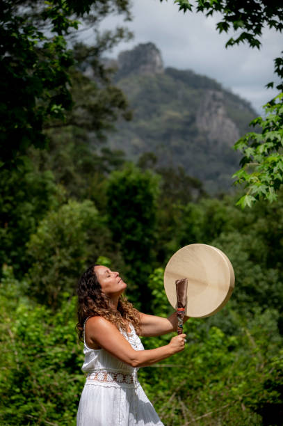 istock Alternative lifestyle woman beats a drum. 1351176304