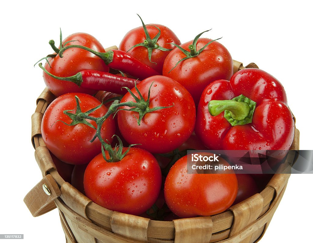 Tomatoes and peppers Red tomatoes and peppers in a basket Basket Stock Photo