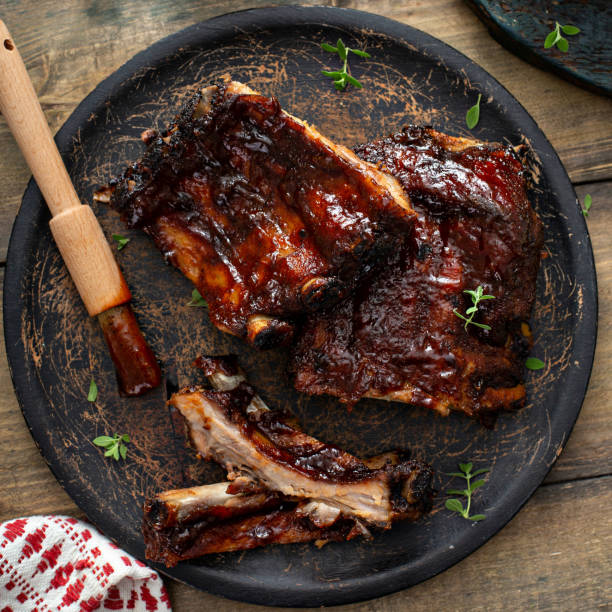 istock Grilled barbeque ribs with BBQ sauce and sides 1351182260
